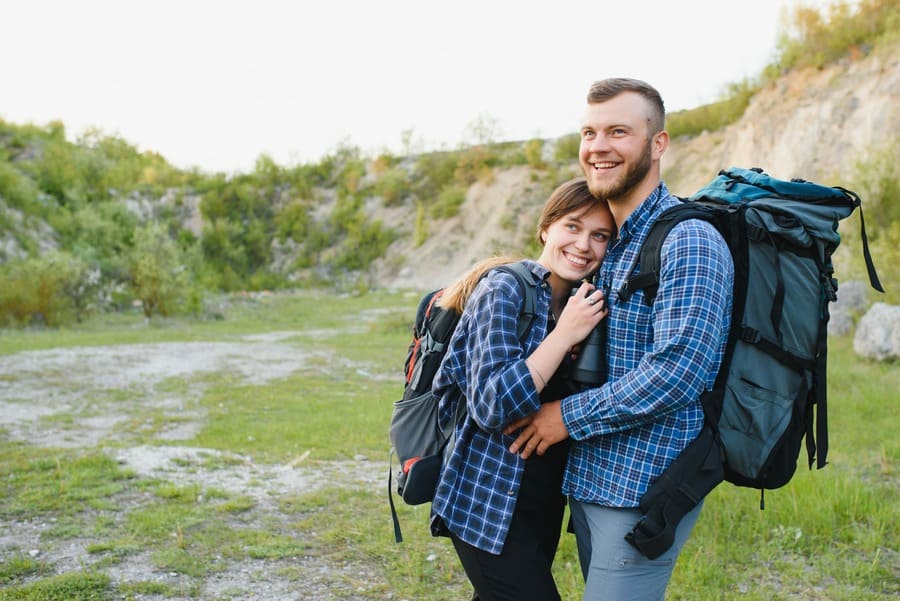 happy young couple hiking in mountain